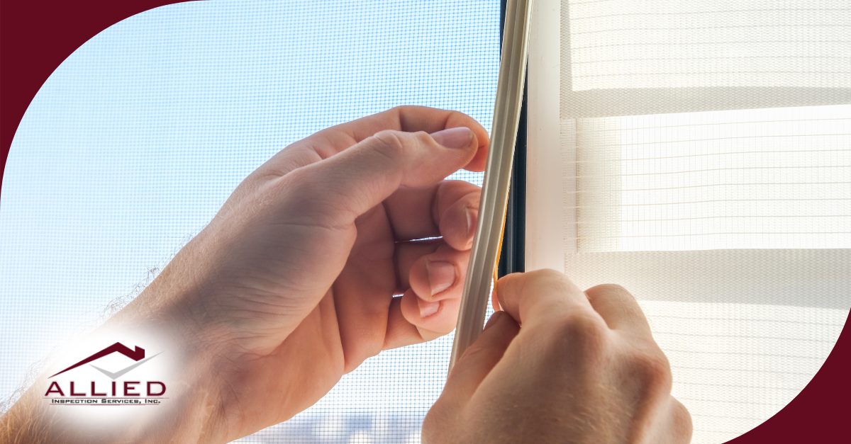Applying weatherstripping to a window frame.