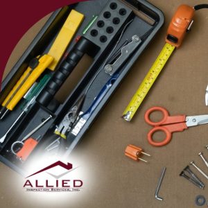 Assorted inspection tools and fasteners laid out with toolboxes on a brown work surface.