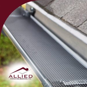 Close-up of a roof gutter guard installed on a roof.